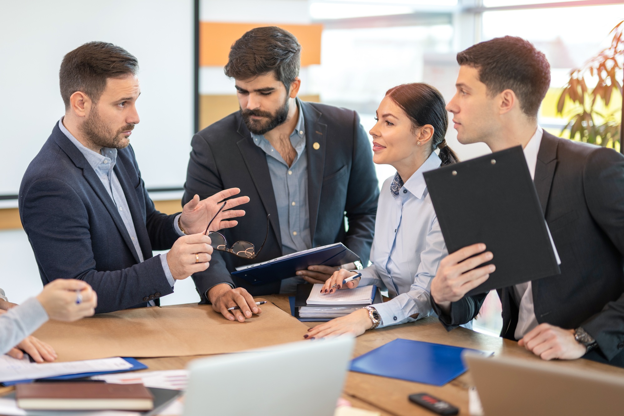 Business executive explaining ideas in project to his coworkers during brainstorming in office